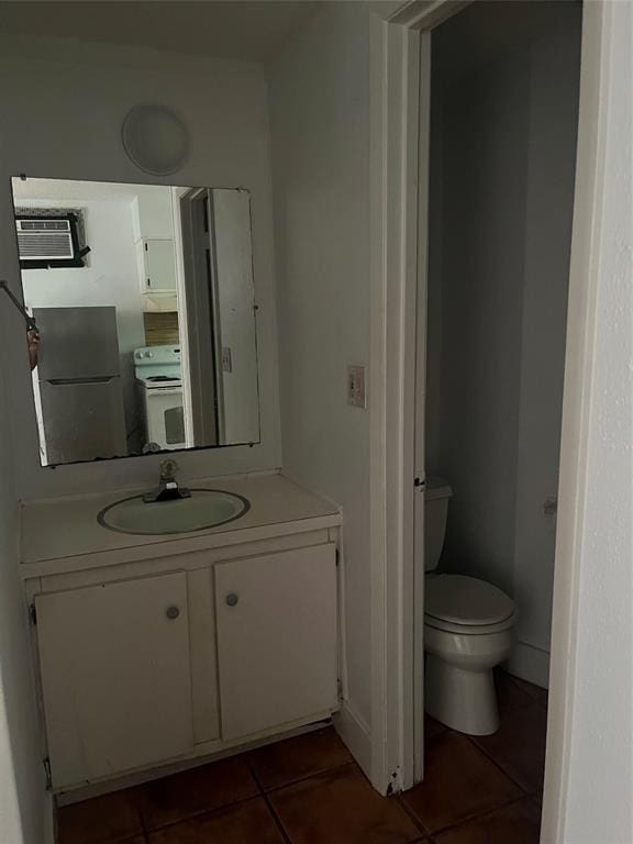 bathroom featuring tile patterned flooring, vanity, toilet, and a wall mounted AC