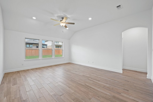 empty room featuring ceiling fan, light hardwood / wood-style floors, and vaulted ceiling