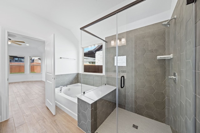 bathroom featuring shower with separate bathtub, ceiling fan, and wood-type flooring