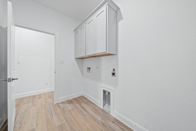 laundry area featuring hookup for an electric dryer, washer hookup, light wood-type flooring, and cabinets