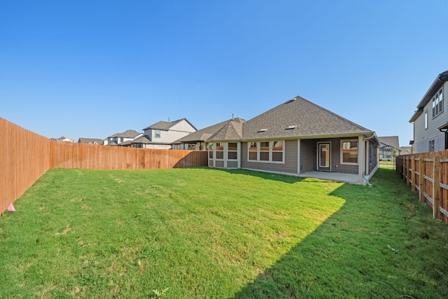 rear view of property with a lawn