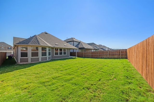 rear view of property featuring a yard