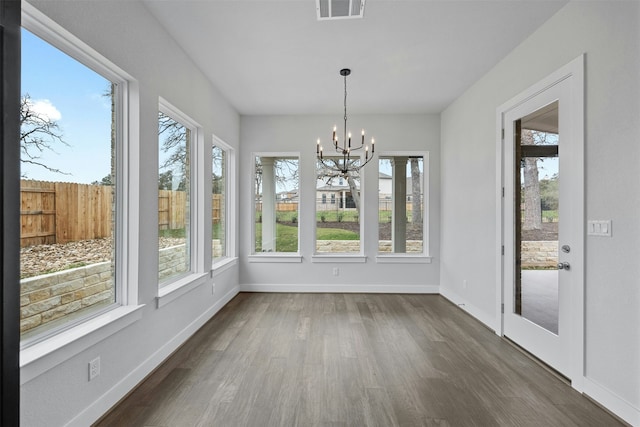 unfurnished sunroom with a chandelier