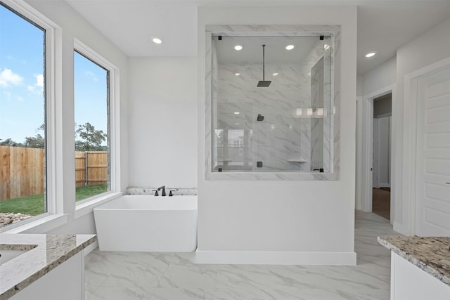 bathroom featuring vanity and independent shower and bath