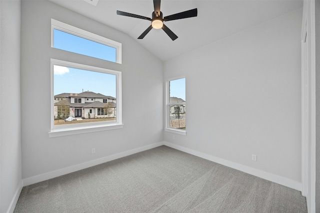 carpeted spare room with lofted ceiling and ceiling fan