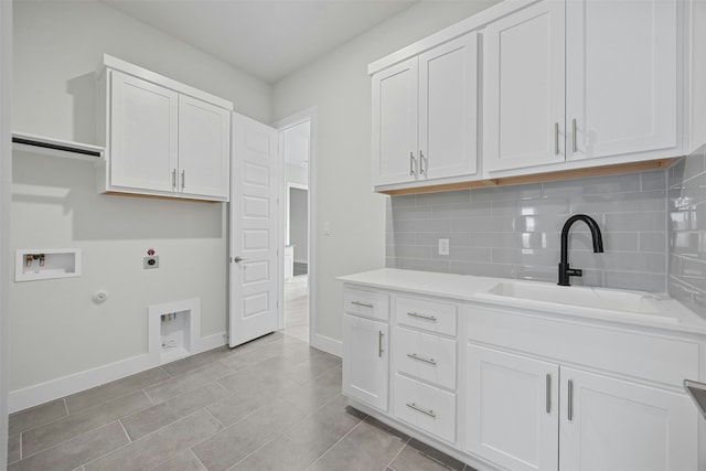 washroom featuring sink, gas dryer hookup, cabinets, washer hookup, and hookup for an electric dryer