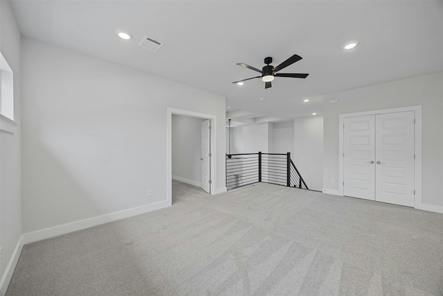 unfurnished room with light carpet and ceiling fan