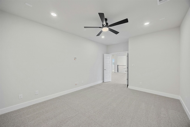 carpeted spare room featuring ceiling fan