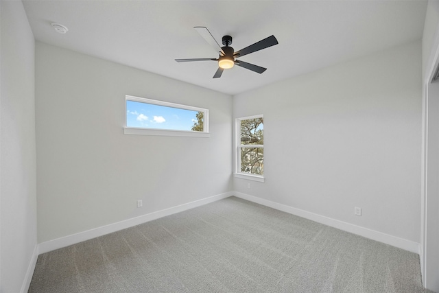 empty room featuring carpet flooring and ceiling fan