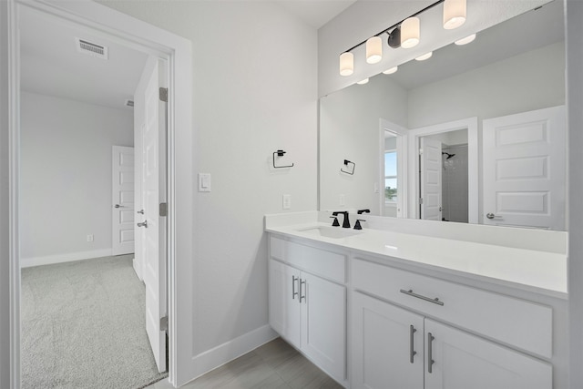 bathroom with vanity and a shower