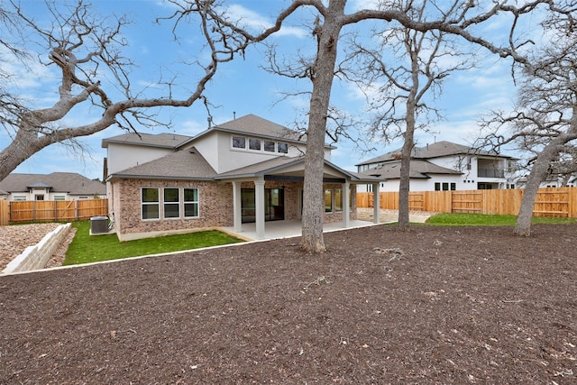 rear view of property with cooling unit and a patio area