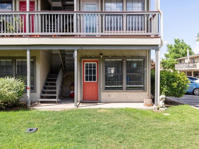 property entrance with a yard