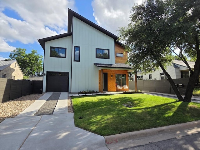 view of front of property with a front lawn and a garage