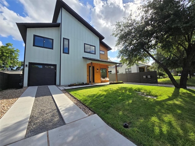 modern farmhouse with a front yard and a garage