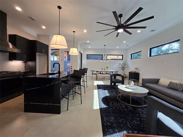 living room featuring sink and ceiling fan