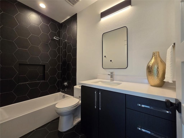 full bathroom featuring tiled shower / bath, oversized vanity, tile flooring, and toilet