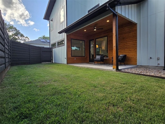 rear view of property with a patio and a yard