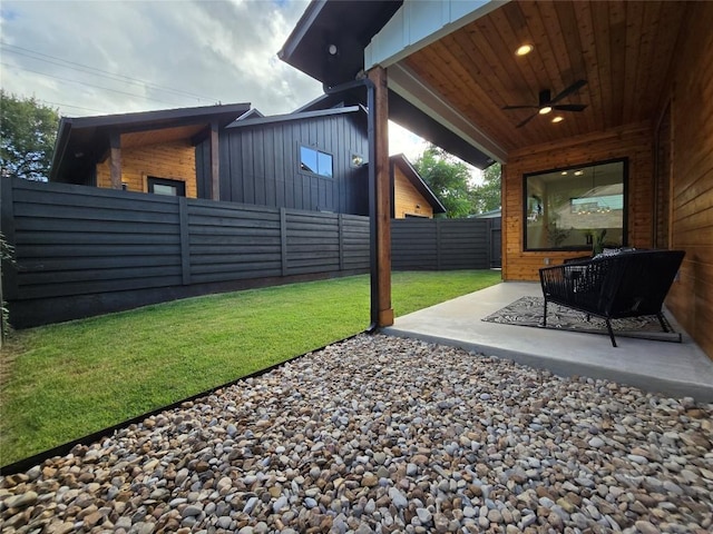 view of yard featuring ceiling fan and a patio area