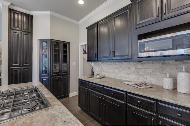 kitchen featuring backsplash, crown molding, and stainless steel appliances