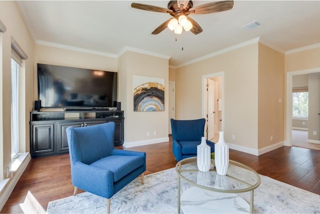 living room with ceiling fan, dark hardwood / wood-style flooring, crown molding, and a wealth of natural light