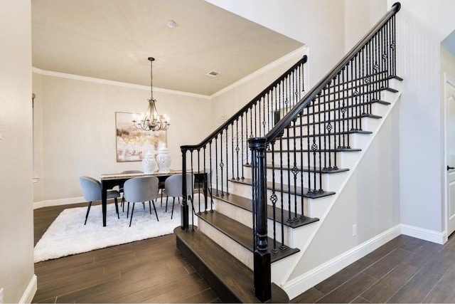 staircase with crown molding, wood-type flooring, and a notable chandelier