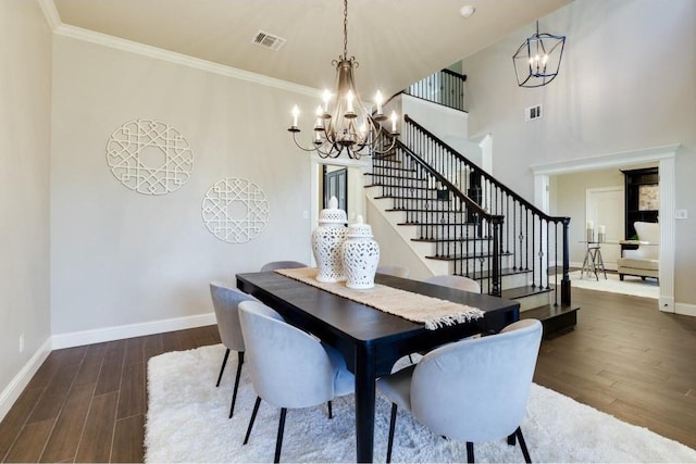 dining room with a chandelier, ornamental molding, and dark wood-type flooring