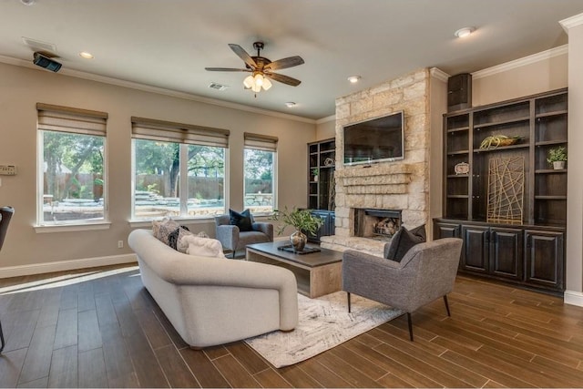 living room with ceiling fan, a fireplace, dark hardwood / wood-style floors, and ornamental molding