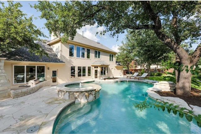 view of swimming pool featuring an in ground hot tub and a patio