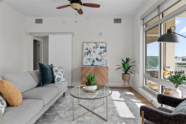 living room featuring hardwood / wood-style floors and ceiling fan