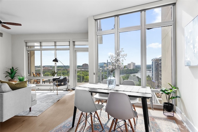 dining room featuring ceiling fan, a healthy amount of sunlight, and hardwood / wood-style floors