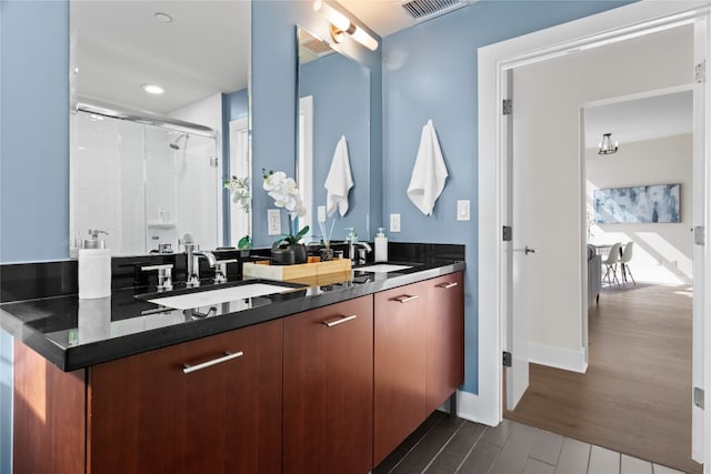 bathroom with vanity, hardwood / wood-style flooring, and an enclosed shower