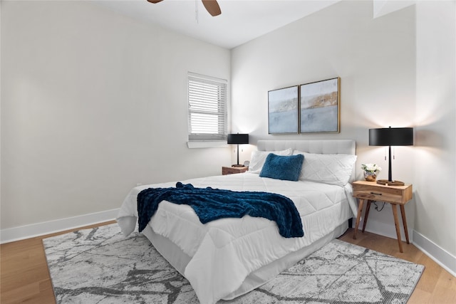 bedroom with light hardwood / wood-style floors and ceiling fan