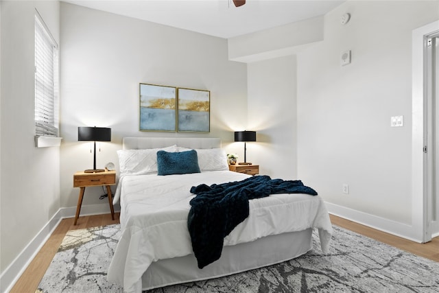 bedroom with light wood-type flooring and ceiling fan