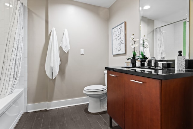 full bathroom with shower / bath combination with curtain, toilet, and vanity