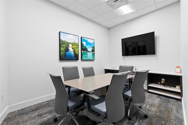 office area with dark carpet and a paneled ceiling