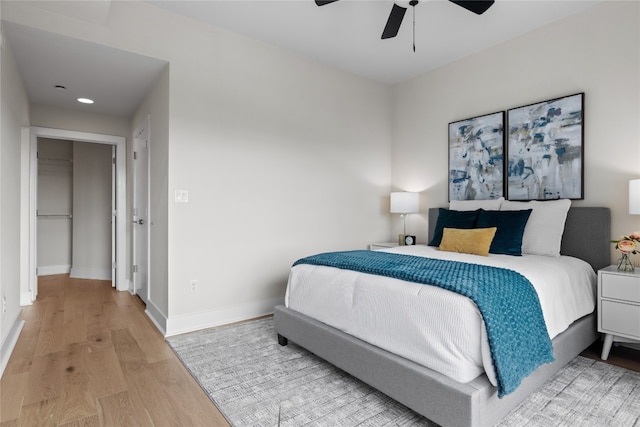 bedroom with light hardwood / wood-style floors and ceiling fan