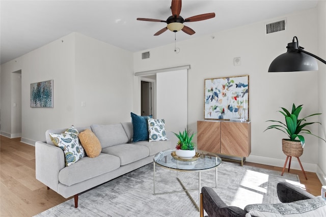 living room with ceiling fan and hardwood / wood-style flooring