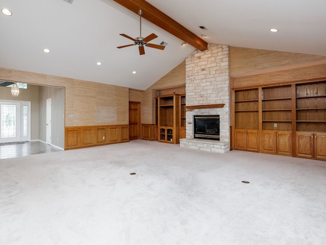 unfurnished living room featuring high vaulted ceiling, carpet, ceiling fan, and a fireplace