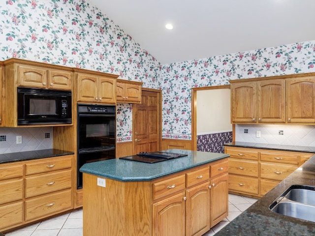 kitchen with black appliances, tasteful backsplash, light tile floors, and a kitchen island