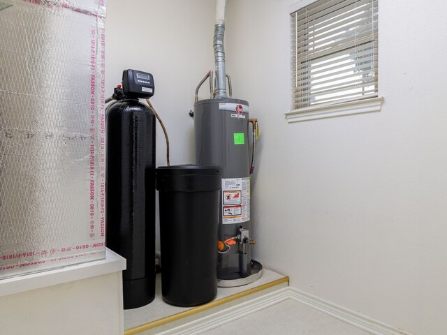 utility room featuring gas water heater