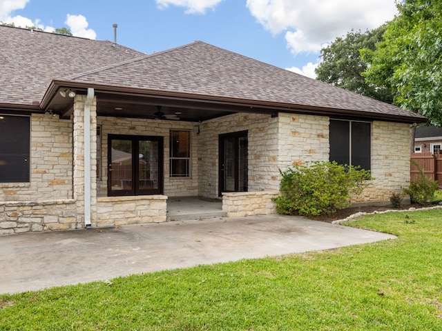 rear view of property with a patio area, a lawn, and ceiling fan