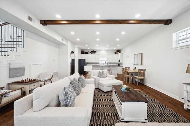 living room with hardwood / wood-style flooring and beamed ceiling