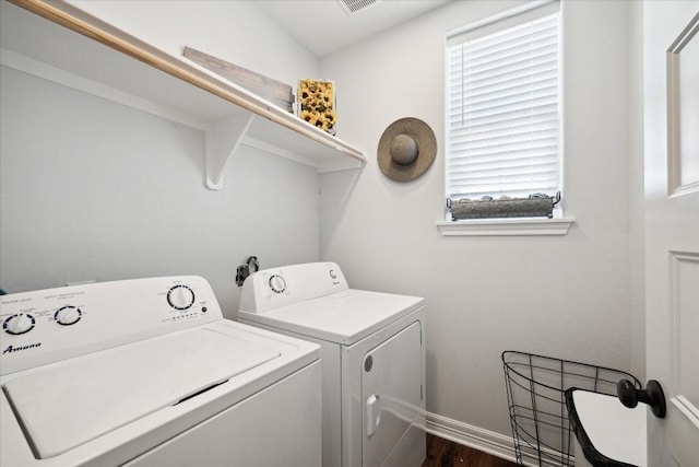 washroom with dark wood-type flooring and washing machine and clothes dryer