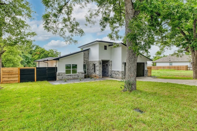 rear view of property featuring a lawn and a garage