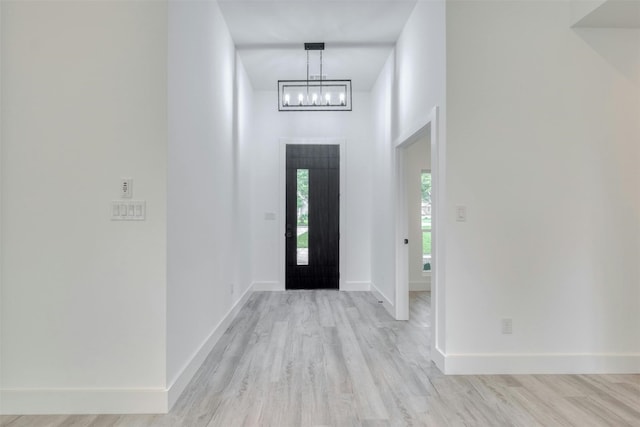 entrance foyer with light hardwood / wood-style flooring and a high ceiling