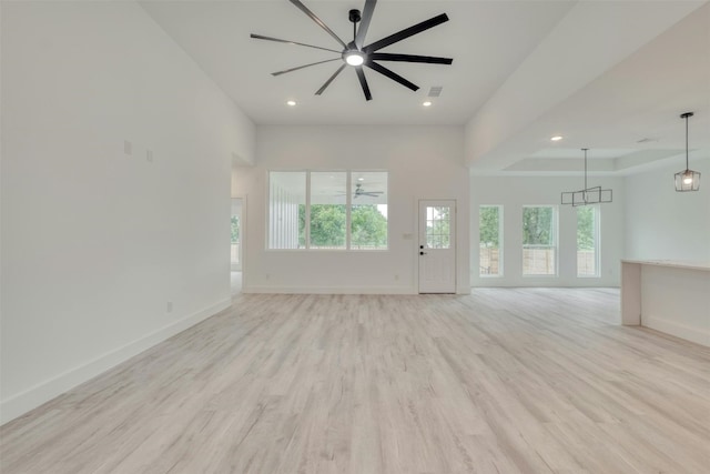 unfurnished living room featuring light hardwood / wood-style flooring, ceiling fan, and a healthy amount of sunlight