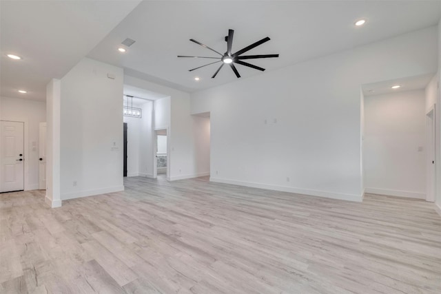 unfurnished living room with ceiling fan and light hardwood / wood-style flooring