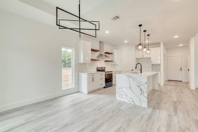 kitchen with white cabinetry, electric range, an island with sink, and decorative light fixtures