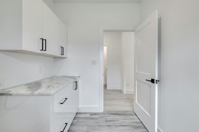 kitchen featuring white cabinets and light hardwood / wood-style floors