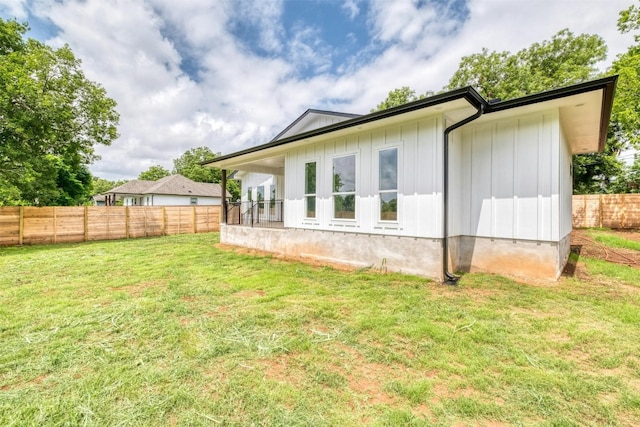 rear view of house with a lawn